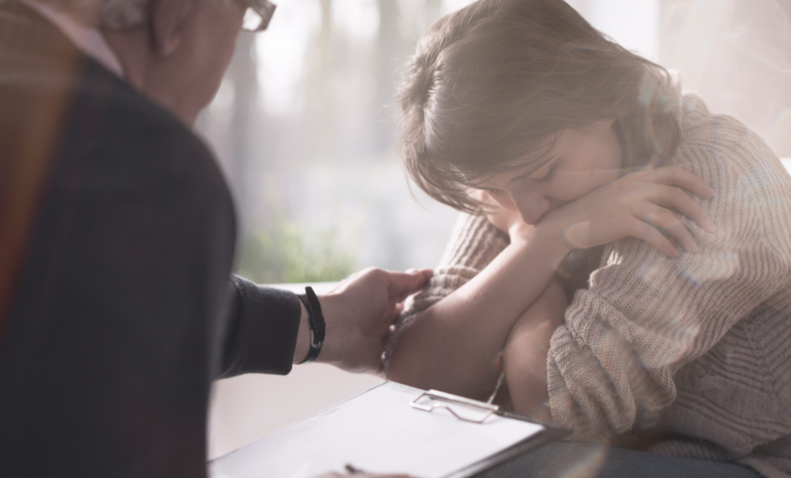 Psychologist comforting depressed and worried patient with phobia